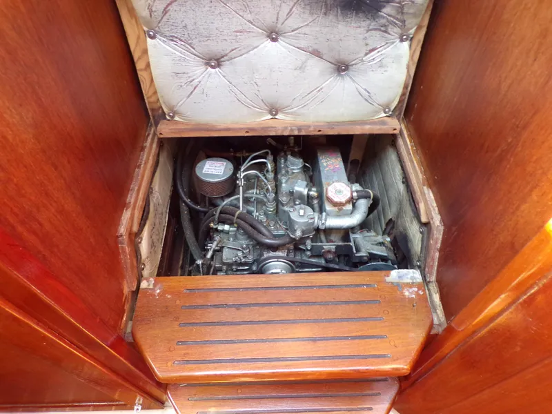 Slide: The Image of Engine compartment of a 1991 Catalina 34 sailboat, featuring a compact marine engine. - 24