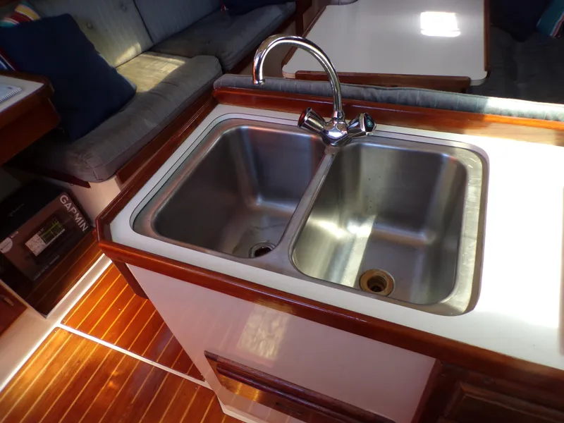 Slide: The Image of 1991 Catalina 34 yacht interior with double sink and wooden flooring. - 25