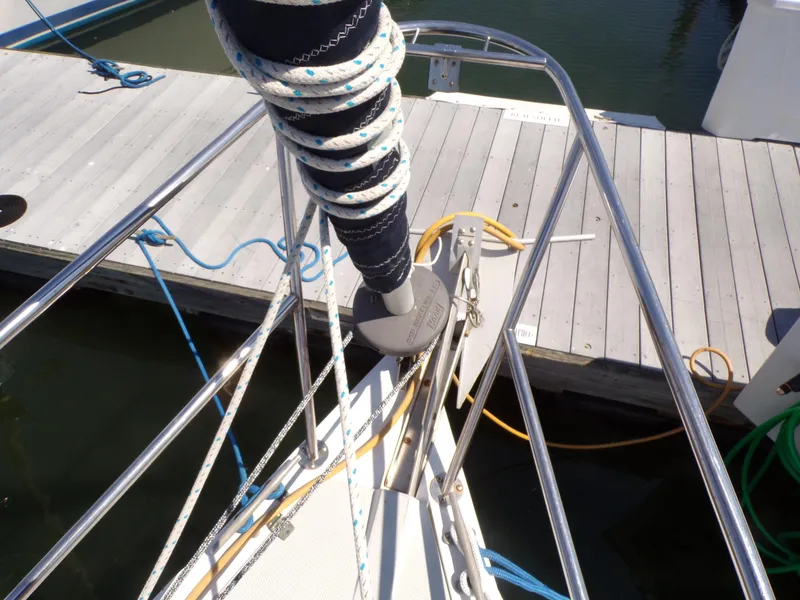 Slide: The Image of Bow of a 1991 Catalina 34 sailboat docked, with ropes and metal railings visible. - 30