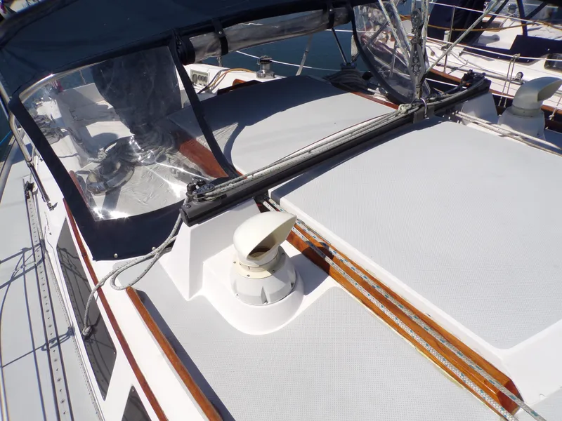 Slide: The Image of 1991 Catalina 34 sailboat deck with protective cover and clear cockpit enclosure. - 32