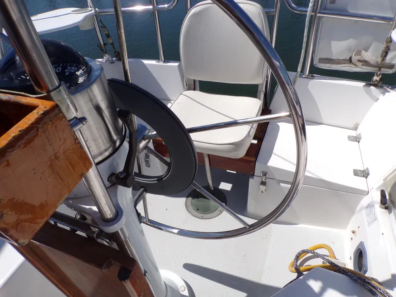 Slide: The Image of Cockpit of 1991 Catalina 34 sailboat with steering wheel and seating. - 6