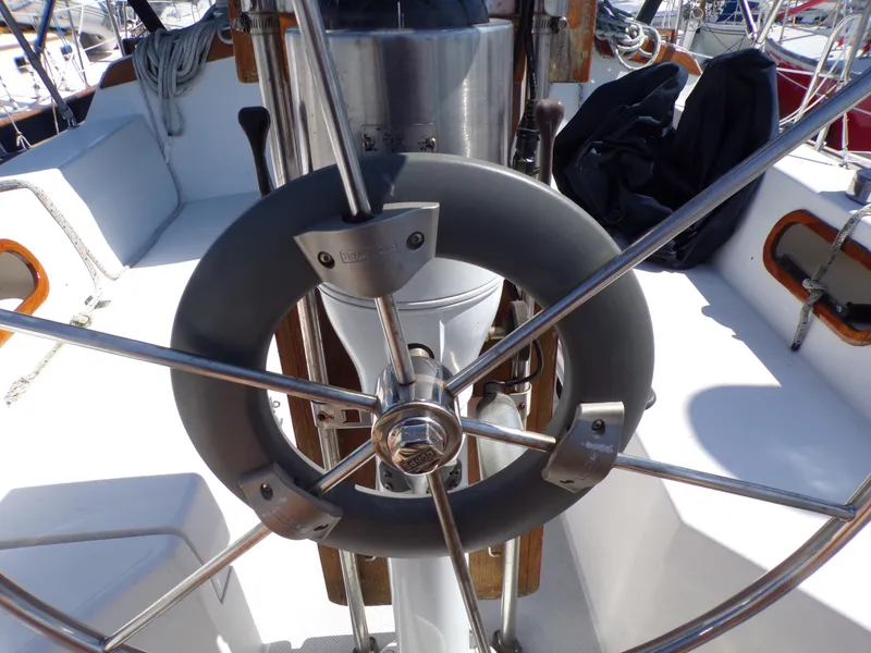 Slide: The Image of Steering wheel of a 1991 Catalina 34 sailboat, featuring stainless steel spokes. - 8
