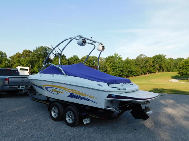 Slide: The Image of 2002 Baja 212 Islander boat on trailer, blue cover, parked outdoors. - 1