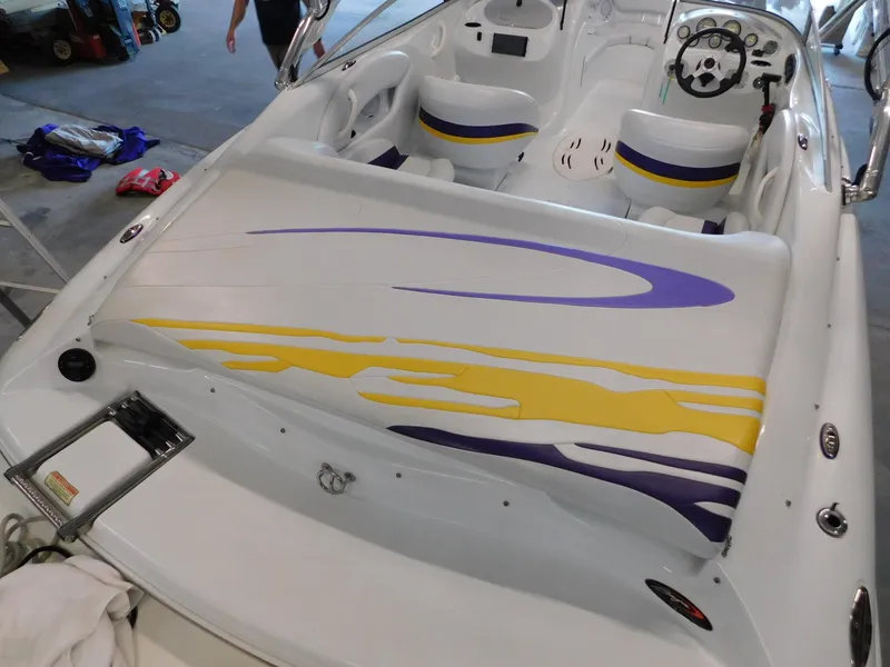 Slide: The Image of 2002 Baja 212 Islander boat interior with colorful seating and steering wheel. - 10