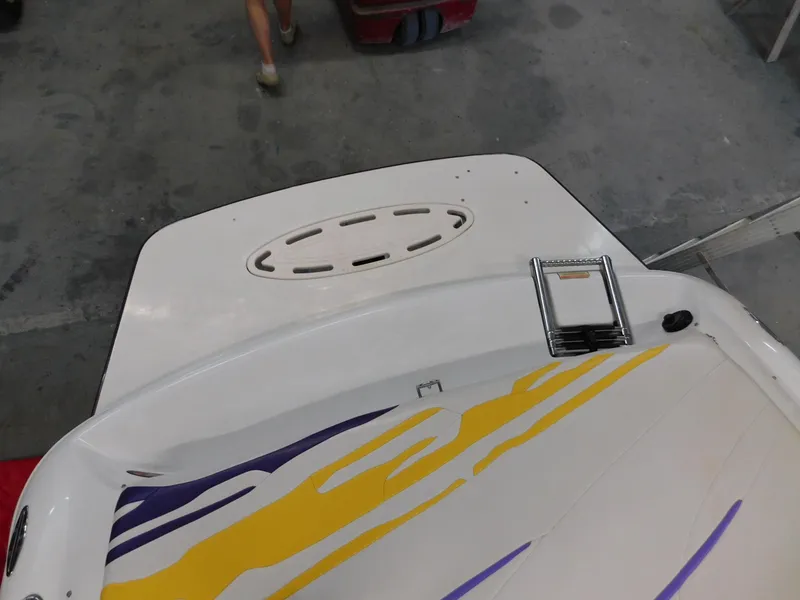 Slide: The Image of 2002 Baja 212 Islander boat with colorful graphics and swim platform. - 11