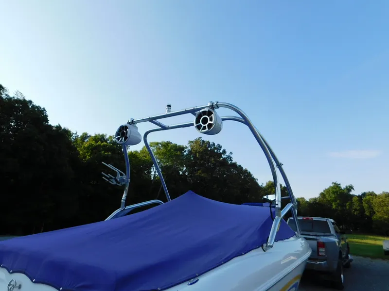 Slide: The Image of 2002 Baja 212 Islander boat with blue cover and wakeboard tower speakers. - 16
