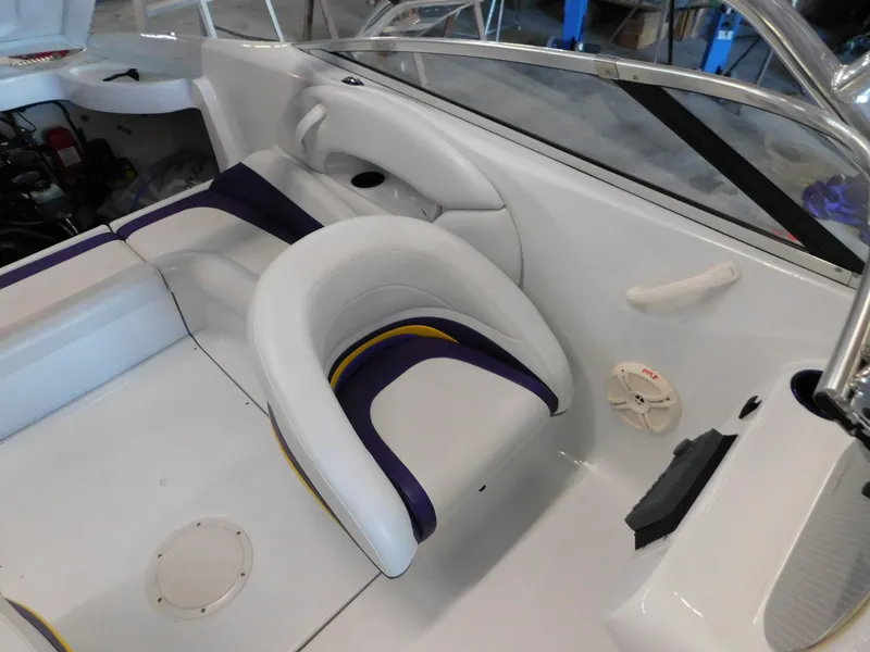 Slide: The Image of 2002 Baja 212 Islander boat interior with white and purple seating. - 4