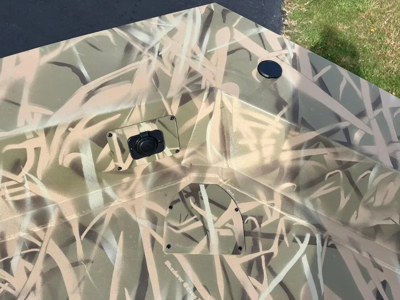 Slide: The Image of 2025 Lowe Roughneck 1760SC boat with camouflage pattern and deck features. - 11