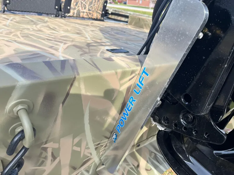 Slide: The Image of 2025 Lowe Roughneck 1760SC boat with Power Lift feature, camo design. - 22