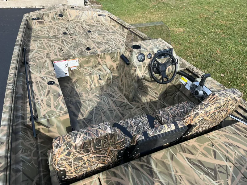 Slide: The Image of 2025 Lowe Roughneck 1760SC boat with camouflage design and steering console. - 5