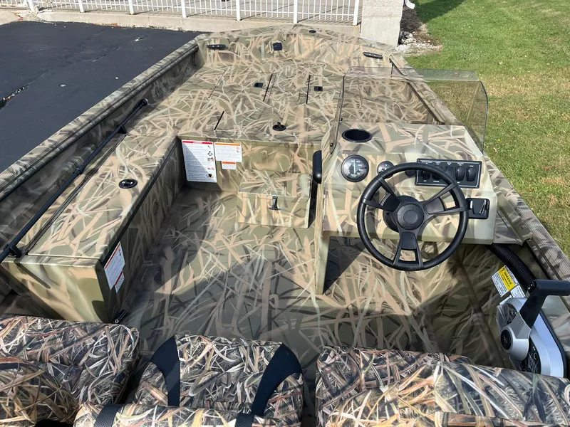 Slide: The Image of 2025 Lowe Roughneck 1760SC boat with camouflage interior and steering console. - 6