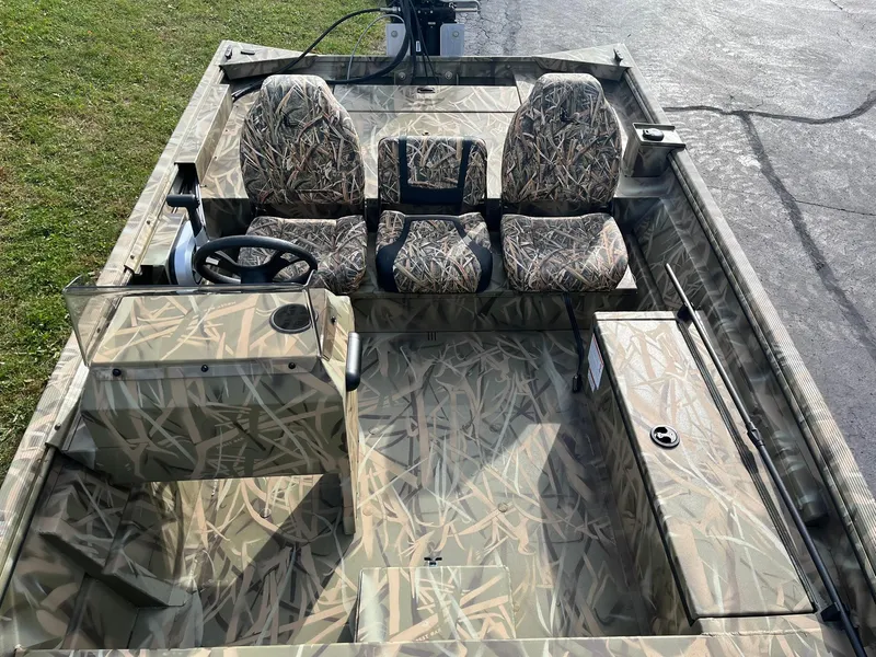 Slide: The Image of 2025 Lowe Roughneck 1760SC boat with camouflage seating and steering console. - 8