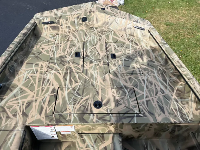 Slide: The Image of 2025 Lowe Roughneck 1760SC boat with camouflage design on deck. - 9