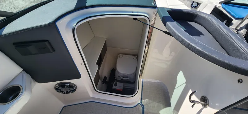 Slide: The Image of 2021 Regal LS6 Surf boat interior with compact toilet compartment. - 10
