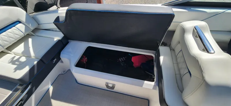 Slide: The Image of 2021 Regal LS6 Surf boat interior with open storage compartment. - 12