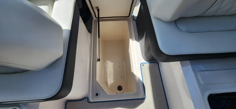 Slide: The Image of 2021 Regal LS6 Surf boat interior storage compartment with open lid. - 14