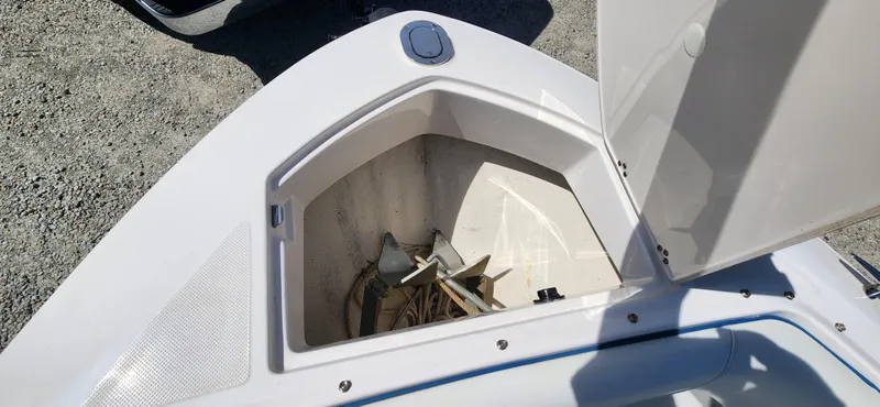 Slide: The Image of Open storage compartment on 2021 Regal LS6 Surf boat. - 16
