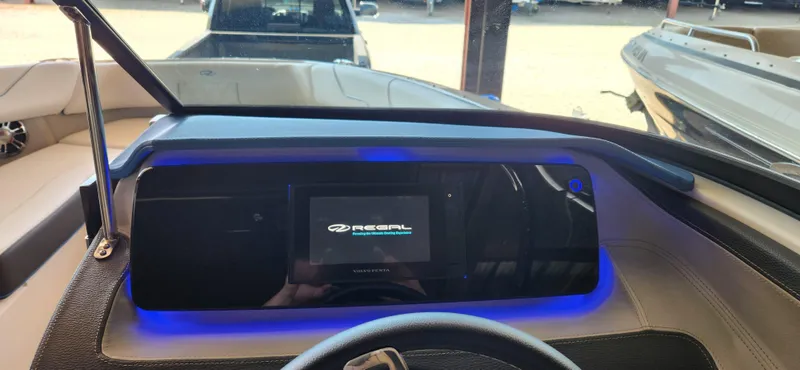 Slide: The Image of 2021 Regal LS6 Surf boat dashboard with illuminated display and steering wheel. - 18