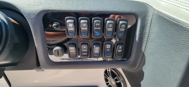 Slide: The Image of Control panel of 2021 Regal LS6 Surf boat with various switches and buttons. - 19