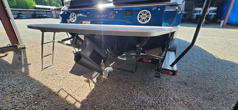 Slide: The Image of 2021 Regal LS6 Surf boat rear view with propeller and swim platform. - 4