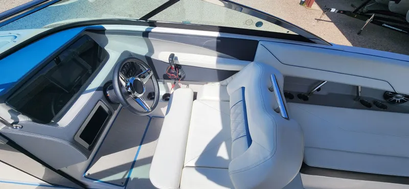 Slide: The Image of 2021 Regal LS6 Surf boat interior with sleek dashboard and comfortable seating. - 8