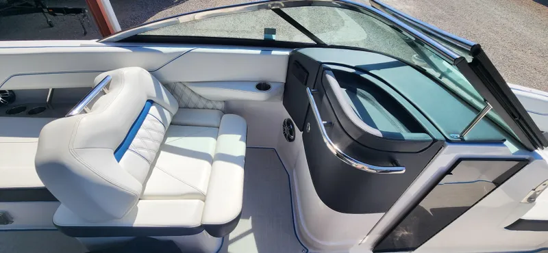 Slide: The Image of 2021 Regal LS6 Surf boat interior with sleek seating and modern dashboard design. - 9