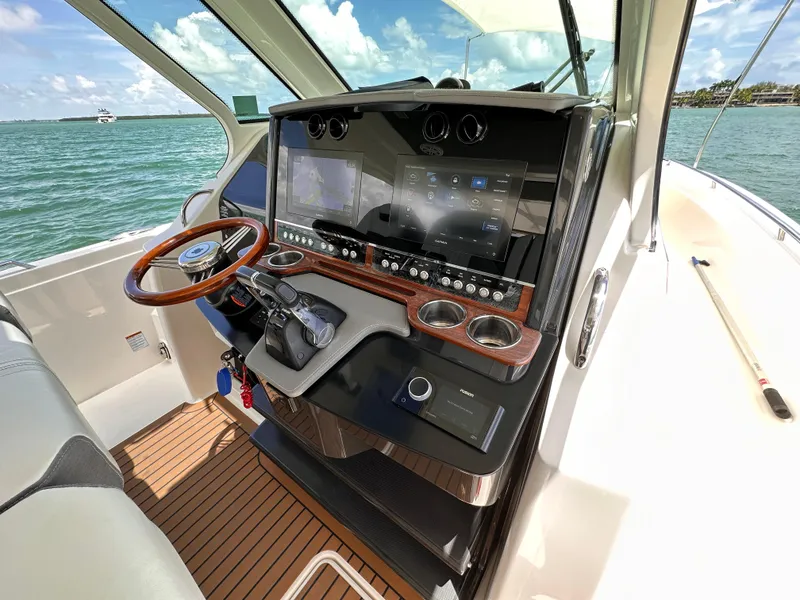 Slide: The Image of 2021 Tiara Sport 34 LS helm with modern controls and ocean view. - 10