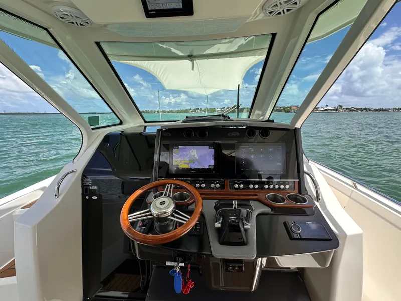 Slide: The Image of 2021 Tiara Sport 34 LS boat helm with advanced navigation system and ocean view. - 11