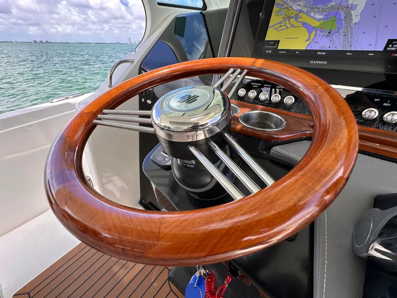 Slide: The Image of 2021 Tiara Sport 34 LS boat steering wheel with navigation display. - 12