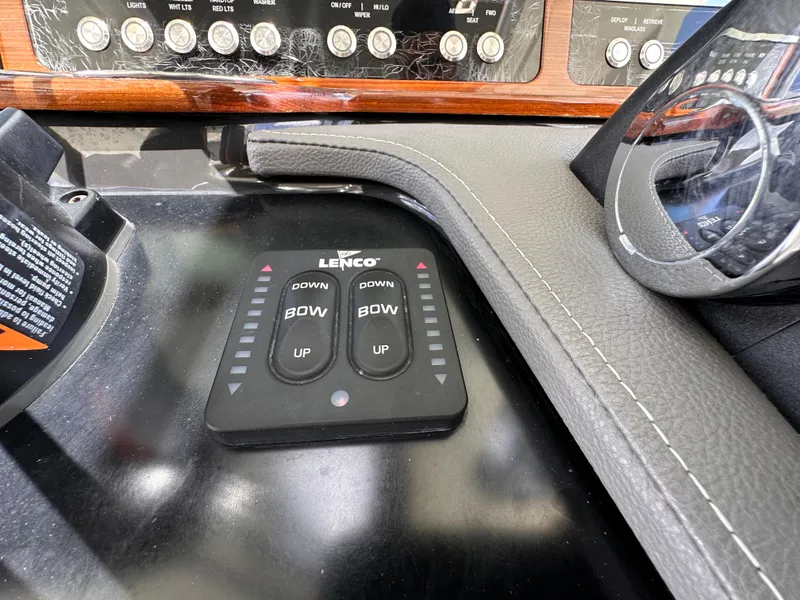 Slide: The Image of Control panel of a 2021 Tiara Sport 34 LS boat with Lenco trim tab switches. - 15