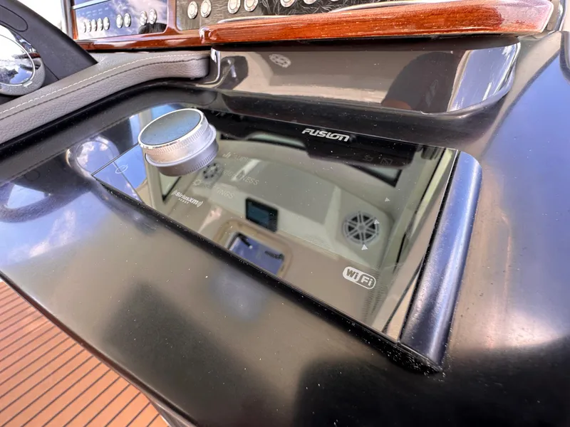 Slide: The Image of 2021 Tiara Sport 34 LS boat dashboard with Fusion audio system. - 16