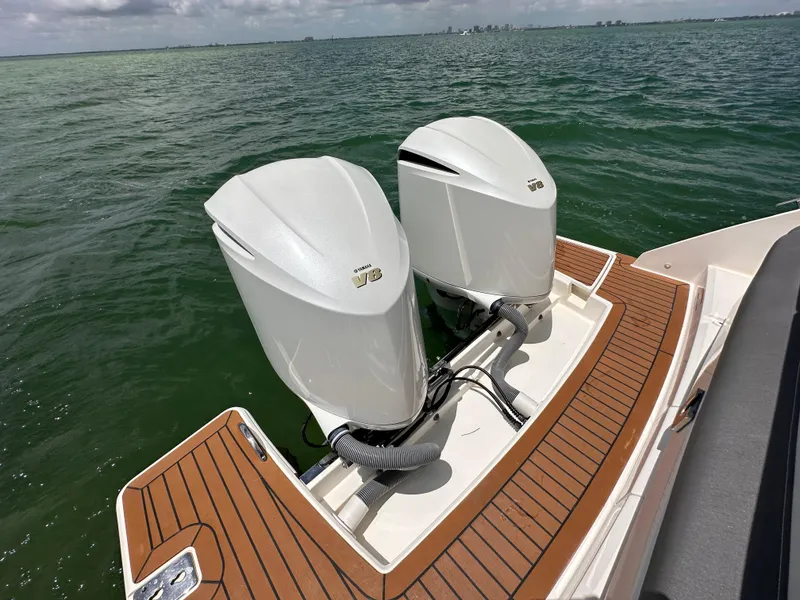 Slide: The Image of 2021 Tiara Sport 34 LS boat with twin outboard engines on water. - 20