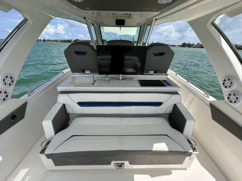 Slide: The Image of 2021 Tiara Sport 34 LS boat interior with seating, ocean view, and modern design. - 21
