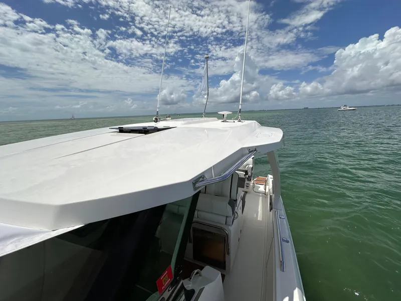 Slide: The Image of 2021 Tiara Sport 34 LS boat on calm sea under blue sky. - 24