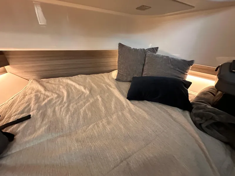 Slide: The Image of Cozy cabin interior of 2021 Tiara Sport 34 LS with pillows and soft lighting. - 31