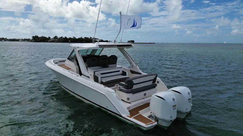 Slide: The Image of 2021 Tiara Sport 34 LS boat on calm water under a partly cloudy sky. - 4