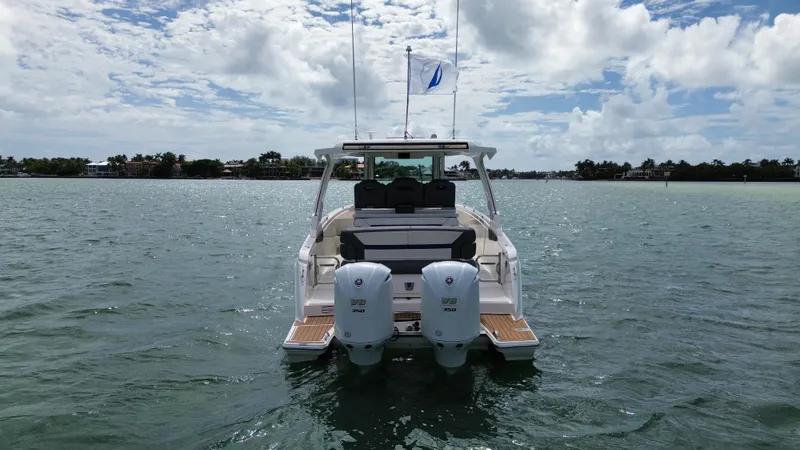 Slide: The Image of 2021 Tiara Sport 34 LS boat on water, rear view with twin engines. - 5