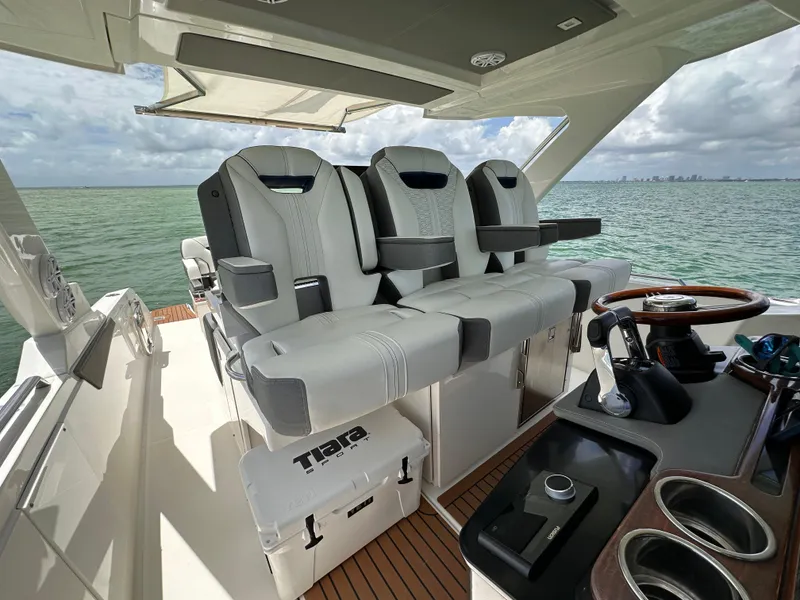 Slide: The Image of 2021 Tiara Sport 34 LS boat interior with luxury seating and helm, ocean view. - 9