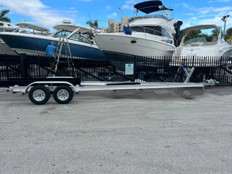 Slide: The Image of 2024 trailer parked near boats in a marina setting. - 0