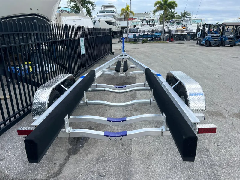 Slide: The Image of 2024 boat trailer with metal frame and padded supports in a marina setting. - 11