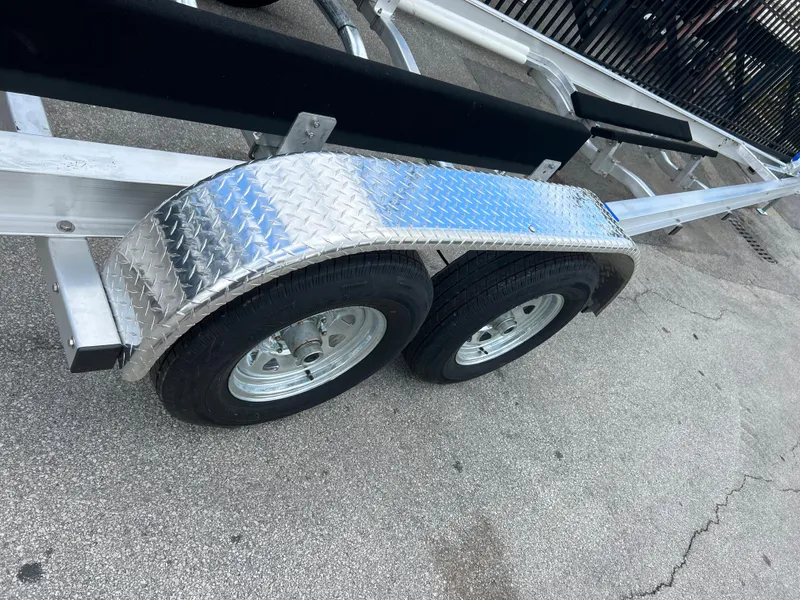 Slide: The Image of 2024 trailer with dual wheels and diamond plate fender on concrete surface. - 12