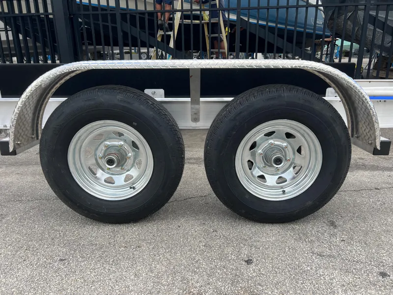 Slide: The Image of 2024 trailer with dual wheels and metal fenders on concrete surface. - 13