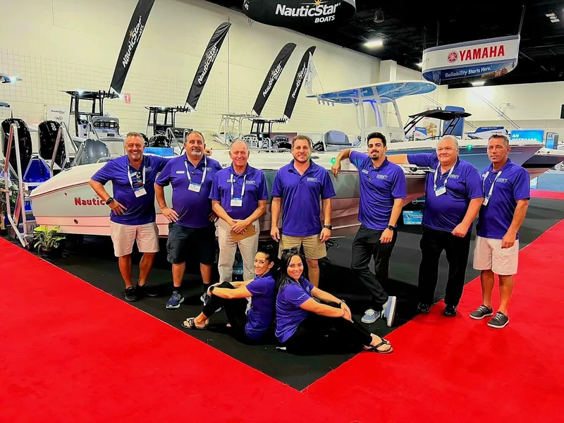 Slide: The Image of Group of people in blue shirts at a boat show with NauticStar display. - 18