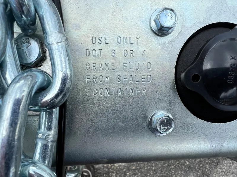 Slide: The Image of Trailer brake fluid warning label, 2024 model, instructs using DOT 3 or 4 fluid. - 3