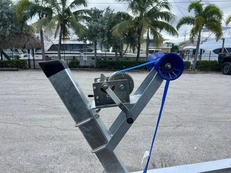 Slide: The Image of 2024 trailer winch with blue strap in a parking lot. - 5