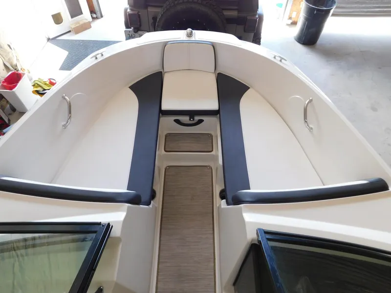 Slide: The Image of 2015 Sea Ray 19 SPX boat interior with cushioned seating and storage. - 10