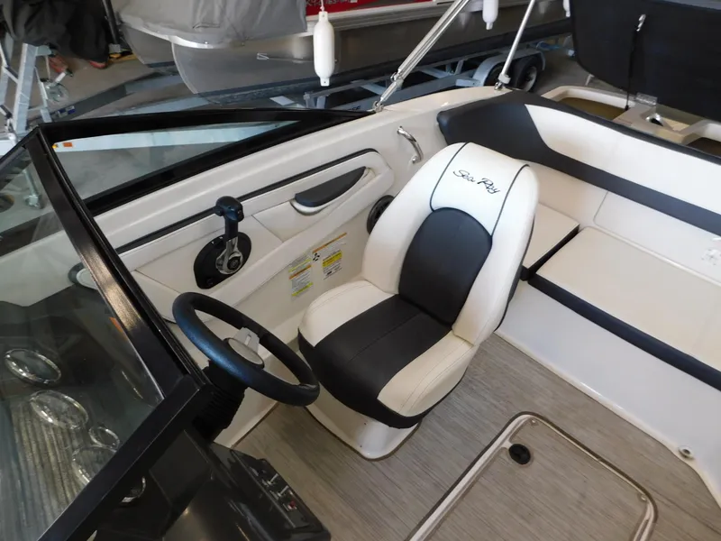 Slide: The Image of 2015 Sea Ray 19 SPX boat interior with steering wheel and seating. - 12