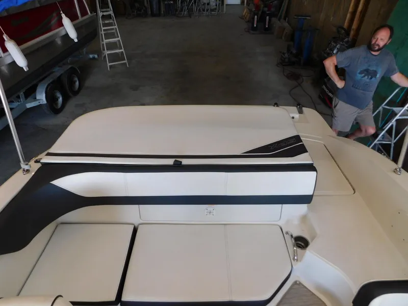 Slide: The Image of 2015 Sea Ray 19 SPX boat interior in a garage setting. - 14