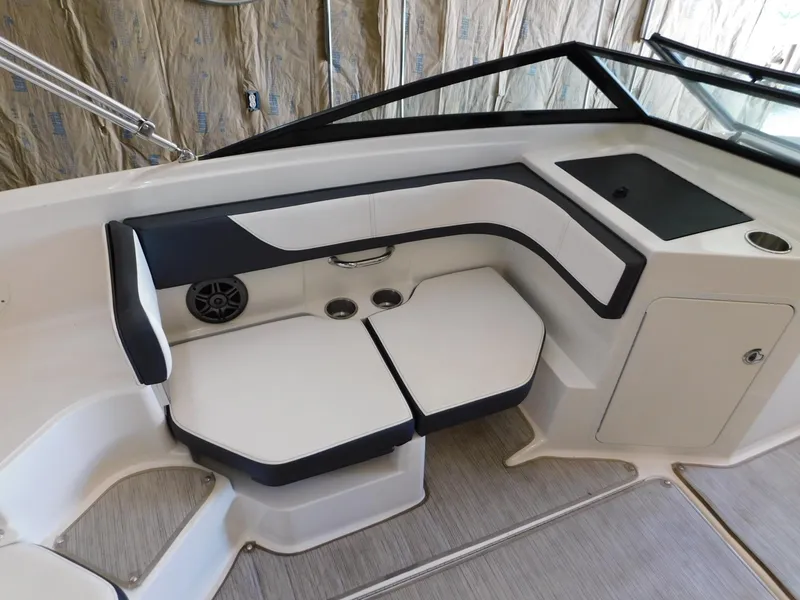 Slide: The Image of 2015 Sea Ray 19 SPX boat interior with white and black seating and storage compartment. - 15