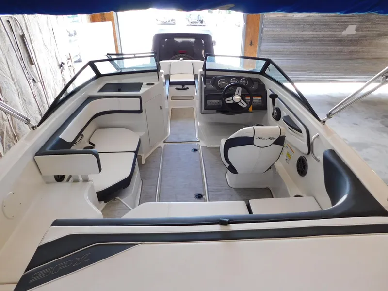 Slide: The Image of 2015 Sea Ray 19 SPX boat interior with seating and steering console. - 18